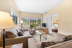 a living room with a couch and a tv at Greens at Copper 214 by Summit County Mountain Retreats in Copper Mountain