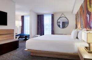 a hotel room with a large bed and a mirror at The LINQ Hotel & Casino, A Caesars Destination in Las Vegas +58 photos