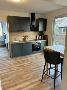 a kitchen with a wooden floor and a table at Rathauswiese Ferienwohnung in Braunlage