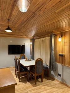a dining room with a table and chairs at Pine Forest Retreat in Kurseong