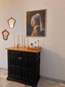 a painting of a woman with a cross on a wall at La casa di Michelle in Foggia