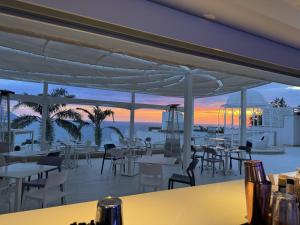 a restaurant on the beach with tables and chairs at Al Chiar di Luna in Monte di Procida