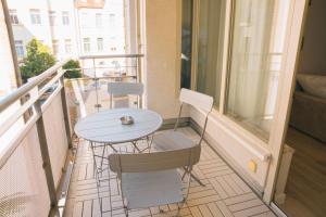 a balcony with a table and chairs on it at RR - NEW - Beautiful Apartment 80qm - Lift - WIFI in Kröllwitz