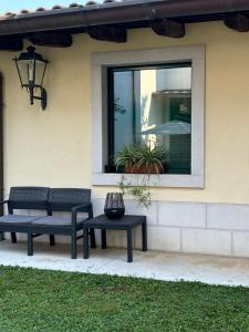 two benches sitting in front of a window at Bed & Breakfast Residenza Cuore in Udine