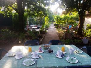 a table with a blue table cloth with food on it at L'ÉCHAPPÉE BELLE in Capdenac-Gare