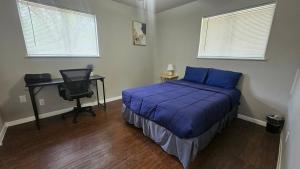 a bedroom with a bed and a desk with a computer at Homey 2br Home Near Downtown & Airport in Austin