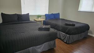 a bedroom with two beds and a night stand at Homey 2br Home Near Downtown & Airport in Austin