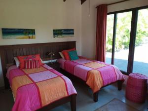 a bedroom with two beds and a large window at Peaceful and Private Villa in Concepción +10 photos