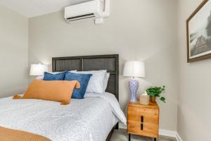 a bedroom with a bed with blue and white pillows at Chic Apt in the Heart of Downtown Canandaigua in Canandaigua