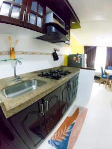 a kitchen with a sink and a stove at Apartamento amplio y acogedor en Bogotá in Bogotá