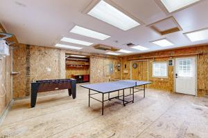 an empty room with a ping pong table in it at Sea Breeze Escape in Warrenton