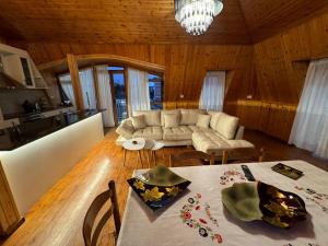 a living room with a table and a couch at The White Troy in Sarandë