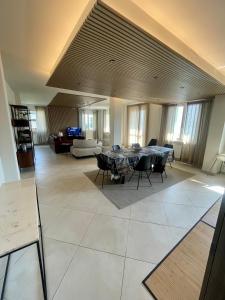 a large living room with a table and chairs at Casa di Giulia in Lovere