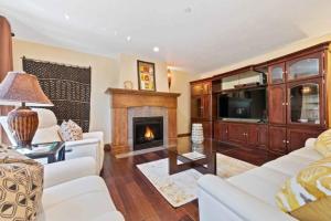 a living room with a white couch and a fireplace at Ascent 305 by East West Hospitality in Avon