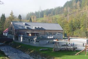 a large building with people standing in front of it at Apartmány - Kouty nad Desnou in Loučná nad Desnou