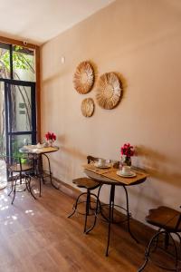 a room with tables and chairs and mirrors on the wall at Fortmar Hotel in Fortaleza +32 photos
