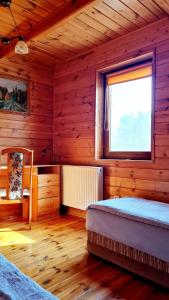 a wooden room with two beds and a window at Trasą S7 w 2h z Warszawy i Gdanska, Jadamowo 16 nad jeziorem Mielno in Olsztynek