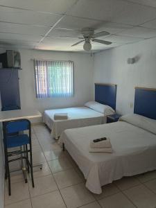 Postel nebo postele na pokoji v ubytování Hotel Vagabundo Expo Guadalajara