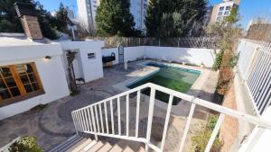 a swimming pool in the backyard of a house at Gold House in Neuquén +6 photos