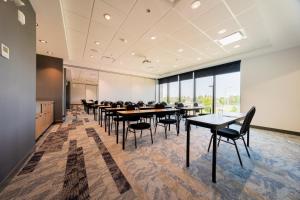 a conference room with tables and chairs and a large window at Candlewood Suites Trois-Rivières Ouest by IHG in Trois-Rivières +52 photos