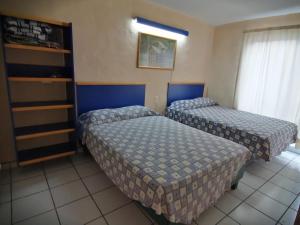 Postel nebo postele na pokoji v ubytování Hotel Vagabundo Expo Guadalajara