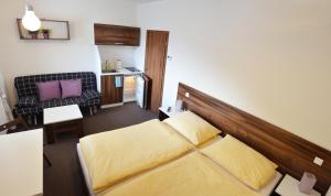 a small room with a bed and a kitchen at Apartmány - Kouty nad Desnou in Loučná nad Desnou