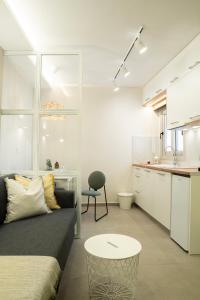 a living room with a couch and a table at Armonía Luxury Apartments in Ierápetra +26 photos