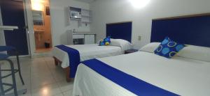 Postel nebo postele na pokoji v ubytování Hotel Vagabundo Expo Guadalajara