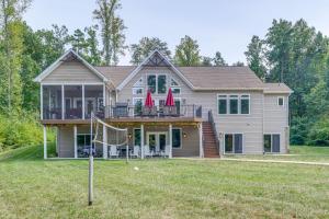 a house with a yard with a goal at Lake Anna Home with Dock and Private Shoreline! in Bumpass