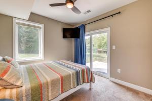a bedroom with a bed and a sliding glass door at Lake Anna Home with Dock and Private Shoreline! in Bumpass