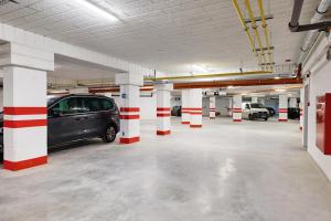 a parking garage with a car parked in it at Baltic Waves Resort & Wellness I Where the Baltic Meets Luxury in Międzyzdroje