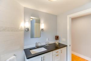 a bathroom with a sink and a mirror at Coastal-Modern Home Less Than 3 Mi to Charlestown Beach! in South Kingstown +22 photos