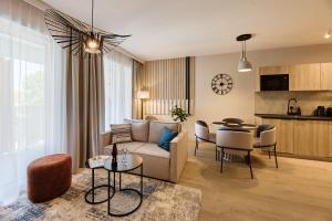 a living room with a couch and a table at Baltic Waves Resort & Wellness I Where the Baltic Meets Luxury in Międzyzdroje +93 photos