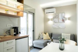 a small living room with a couch and a table at Armonía Luxury Apartments in Ierapetra