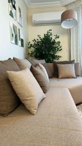 a couch with pillows on it in a living room at Charming apartment In Heliopolis in Cairo