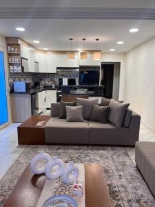 a living room with a couch and a kitchen at Charming apartment In Heliopolis in Cairo