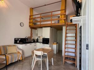 a kitchen and a living room with a loft bed at Casetta Jema in Lumio +9 photos
