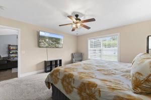 a bedroom with a bed and a ceiling fan at Wander by the Waves Pet Friendly in Palm Coast