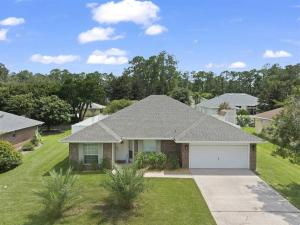 a house with a garage in a residential neighborhood at Wander by the Waves Pet Friendly in Palm Coast