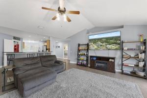 a living room with a couch and a flat screen tv at Wander by the Waves Pet Friendly in Palm Coast