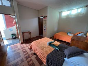 Voodi või voodid majutusasutuse Hostal Cattleya toas