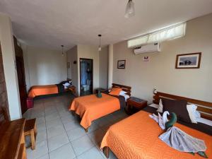 Voodi või voodid majutusasutuse Hostal Cattleya toas
