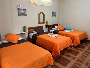 Voodi või voodid majutusasutuse Hostal Cattleya toas