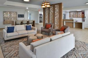 a lobby with couches and chairs and a waiting room at Candlewood Suites Kansas City Northeast by IHG in Kansas City