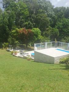 a swimming pool in a park with a grass field at Green Garden in Roussel +34 photos