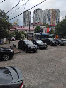 a group of cars parked in a parking lot with tall buildings at Lili's Flat in Angisa
