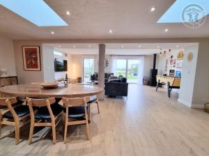 a dining room and living room with a table and chairs at Maison avec grand jardin clos, baby-foot, barbecue, garage, Wi-Fi - Calme et confort en Flandre - FR-1-510-221 in Eecke