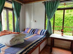 a bedroom with a bed and a window at Springfeel Homestay in Jālāpahār +25 photos