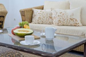 una mesa de centro con un bol de fruta en el sofá en Comeback HOTEL CALIFORNIA, en Calahonda