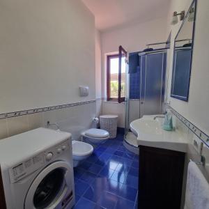 a bathroom with a washing machine and a toilet at La Villa di Nino in Ustica +63 photos
